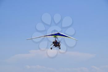 Russia, Veselovka - September 6, 2016: Trike, flying in the sky with two people. Extreme Entertainment travelers.