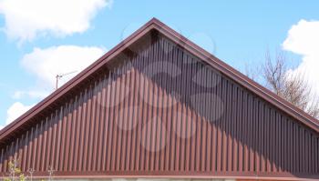The roof of corrugated sheet. Roofing of metal profile wavy shape.