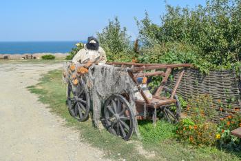 Mannequin fisherman in the wagon. The wagon with fishing nets and fisherman doll with a beard.