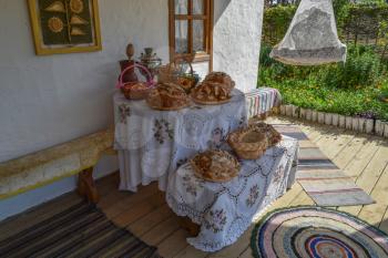 Table with bread baking. Various loaves of bread on the table.