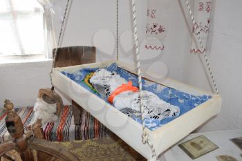 Cradle with dolls in the bedroom. Homemade great toys for children. Recreating the image of antiquity.
