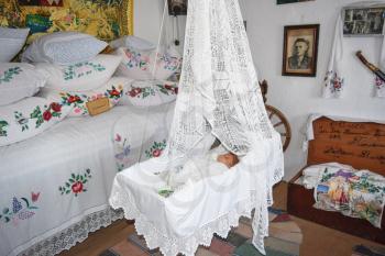 Ataman, Russia - September 26, 2015: Cradle with dolls in the bedroom. Homemade great toys for children. Recreating the image of antiquity.