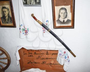Ataman, Russia - September 26, 2015: Interior Cossack home. A wall with pictures of relatives and nominal saber