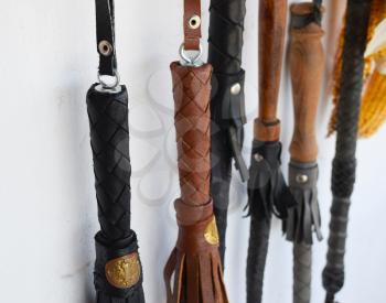 Cossack whip hanging on the wall. Whips leather.