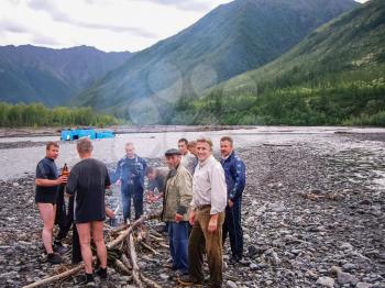 Russia, Nezhdaninskoe - June 23, 2014: The survivors of the sunken car people drying clothes. An accident while crossing a mountain stream. The car carrying workers overturned and fell into the water.