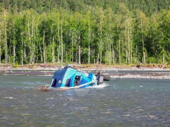Russia, Nezhdaninskoe - June 23, 2014: An accident while crossing a mountain stream. The car carrying workers overturned and fell into the water.