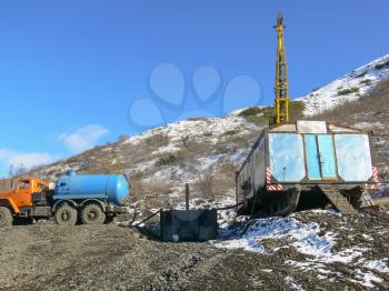 Equipment in place of gold exploration. Caravan with a tower for drilling and coring. Vehicle with technical water.