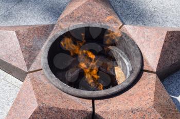 Burning of eternal fire. Five-pointed star made of granite memorial to the memory of killed soldiers.
