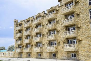 The hotel building, covered with decorative stone. Multi-storey hotel with a decorative trim, which is called Dagestani stone.