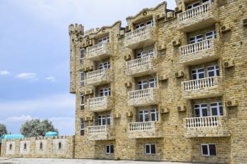 The hotel building, covered with decorative stone. Multi-storey hotel with a decorative trim, which is called Dagestani stone.