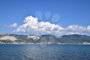 Sea bay landscape Tsemess. Mountains and clouds in the sky. In the distance can be seen the Marine cargo port.