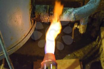 Heating a steel pipe with a blowtorch. The flame of a blowtorch.
