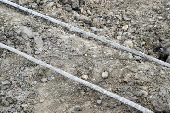 High aluminum wires on the ground. Installation of high-voltage power lines.
