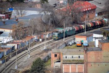 Krasnodar, Russia - February 23, 2017: Freight train traveling through the city buildings