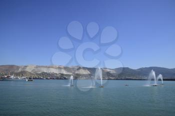 Fountains in the sea. Spray fountains in the bay. Sea port.