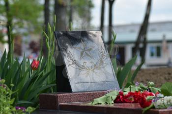 The laid flowers to a monument in honor of a Victory Day on May 9. Patriotic traditions.