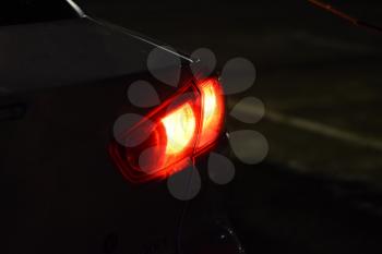 Discounted rear car lights in the dark. Stop signals.