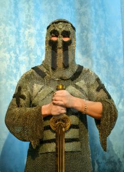 Knightly chain armor and sword. Fitting of a knightly armor.