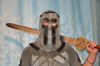 Knightly chain armor and sword. Fitting of a knightly armor.