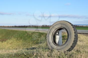 RUSSIA, TRUDOBELIKI - DECEMBER 23, 2015. Rubber tire of a wheel at the intersection. A wheel at the road.