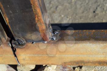 Connection by welding of metal square pipes. Welding seam.