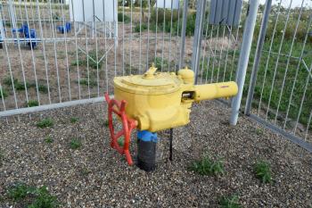 The latch on the underground gas pipeline protected with a fence.