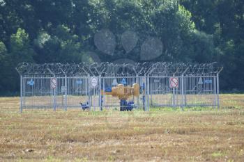 Russia, Slavyansk-on-Kuban - July 28 2015: Fencing valve closing the gas pipeline. On the fence there are signs warning about opastnosti and prohibit unauthorized entrance.
