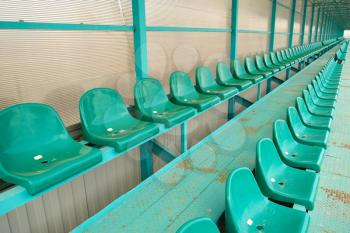 Rows of seats in an empty stadium. Green seats at the stadium.