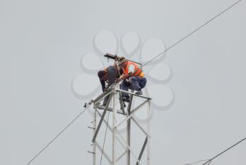 Russia, village Poltavskaya - June 23, 2015: Power line support, insulators and wires. Appearance of a design. Assembly and installation of new support and wires of a power line.