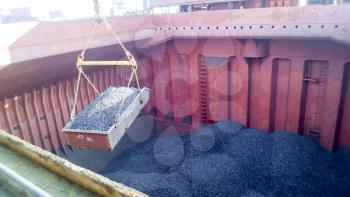 The cargo compartment of the ship, filled with coal. Loading of anthracite. Transportation of coal