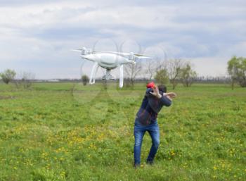 A man hides himself from a collision with a drone. Quadrocopter flies to the person.