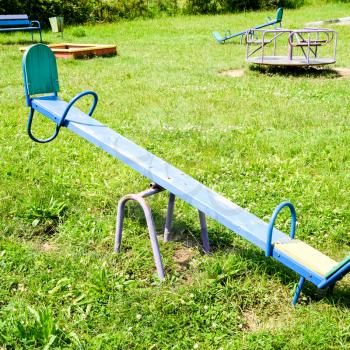 Children's playground. Swing, carousel and slide. Children's rocking chair on the playground.