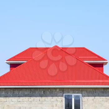 Red corrugated roof. House of cinder block. The house with plastic windows and a roof of corrugated sheet.