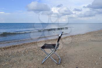 Folding chair by the sea. Convenience to the tourist. Rest by the sea