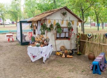 Recreating the rural life of the Cossacks. A hut and a street table with food