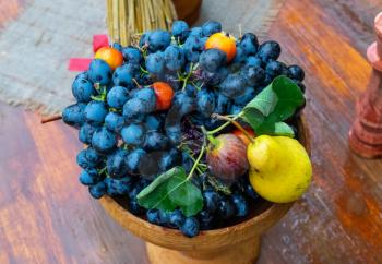 Blue grapes and pears in a vase. Fruit composition