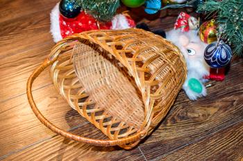 Wicker basket under the Christmas tree. Decorations New Year tree.