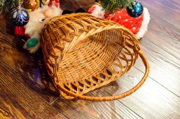 Wicker basket under the Christmas tree. Decorations New Year tree.