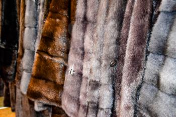 Fur coats on hangers. Fur store. fur coats in a row.