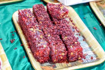 Indian sweets. Sticks of nuts with marmalade, topped with jam and dried fruit