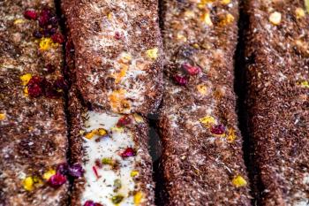 marmalade sticks sprinkled with chocolate and dried berries. Indian and oriental sweets.