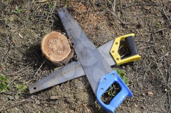 Two saws hacksaws lie across. Garden tool saw. Two saws hacksaws lie across