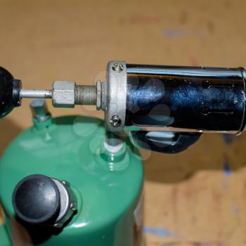 Blowtorch, general view. Blowtorch with a green tank