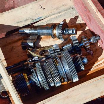 Dismantled box car transmissions. The gears on the shaft of a mechanical transmission.