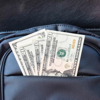 Dollars in the pocket of the bag. American Money.