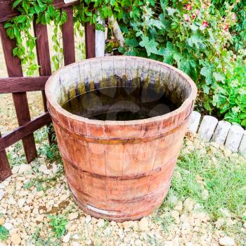 Wooden barrel filled with water. Storage in open water outdoors container.