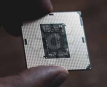 The processor is a desktop computer in hand. Inspect the CPU contacts before installing.