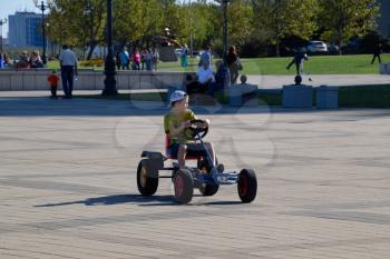 Novorossiysk, Russia - September 29, 2018: Children ride in the park on cars with pedals. Admiral Serebryakov Square. Childrens leisure.