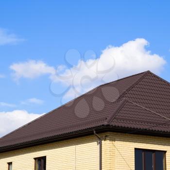 Decorative metal tile on a roof. Types of a roof of roofs. Decorative metal on the roof of the house.