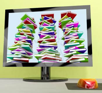 Three Stacks Of Books On Computer Showing Online Learning